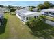 Aerial view of a single-wide manufactured home on a grassy lot at 15 Hamilton Ln # 7, Palm Harbor, FL 34684