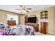 Bedroom with dresser, TV, and walk-in closet at 15 Hamilton Ln # 7, Palm Harbor, FL 34684