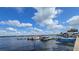 Several boats are docked at a pier on a sunny day with fluffy clouds at 15 Hamilton Ln # 7, Palm Harbor, FL 34684