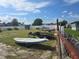 Several boats and jet skis are stored in a lot with a chain-link fence at 15 Hamilton Ln # 7, Palm Harbor, FL 34684