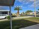Residential street view showing mobile homes and lush landscaping at 15 Hamilton Ln # 7, Palm Harbor, FL 34684