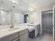 Double vanity bathroom with gray cabinets and a mirror at 3437 Yellow Leaf Cir, Spring Hill, FL 34609