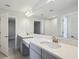 Modern bathroom with double vanity and a large mirror at 3437 Yellow Leaf Cir, Spring Hill, FL 34609