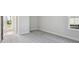 Spacious bedroom with grey carpet and door to exterior at 3437 Yellow Leaf Cir, Spring Hill, FL 34609