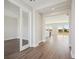 Bright entryway with hardwood floors and view to kitchen and living areas at 3437 Yellow Leaf Cir, Spring Hill, FL 34609