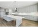 Gray kitchen with large island and stainless steel appliances at 3437 Yellow Leaf Cir, Spring Hill, FL 34609