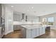 Spacious kitchen with gray cabinets, island, and quartz countertops at 3437 Yellow Leaf Cir, Spring Hill, FL 34609