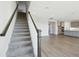 Modern staircase with grey carpet and wooden railing at 3437 Yellow Leaf Cir, Spring Hill, FL 34609