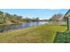 A spacious backyard with a pond view and white picket fence enhances this charming property's appeal at 7806 Grasmere Dr, Land O Lakes, FL 34637