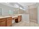 Main bathroom featuring double sinks, granite counters, and a tiled shower at 7806 Grasmere Dr, Land O Lakes, FL 34637