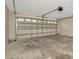 Empty garage featuring a windowed garage door at 7806 Grasmere Dr, Land O Lakes, FL 34637