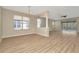 Open-concept living room with wood floors, lots of natural light and ceiling fan at 7806 Grasmere Dr, Land O Lakes, FL 34637