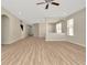 Spacious living room featuring hardwood floors, abundant light, and an open layout at 7806 Grasmere Dr, Land O Lakes, FL 34637