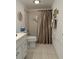 Bathroom with tub and shower, vanity with drawers at 10369 Paradise Blvd # 58, Treasure Island, FL 33706