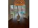 Bright dining room with round table, view of pool at 10369 Paradise Blvd # 58, Treasure Island, FL 33706
