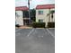 Condo building with parking and landscaping at 10369 Paradise Blvd # 58, Treasure Island, FL 33706