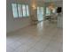 Spacious living room with tile floors and access to dining area at 10369 Paradise Blvd # 58, Treasure Island, FL 33706