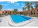 Community pool with plenty of lounge chairs at 10369 Paradise Blvd # 58, Treasure Island, FL 33706