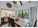 Bright dining room with large windows, wooden table, and chandelier at 1118 2Nd S Ave, Tierra Verde, FL 33715