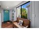 Bright entryway with teal door, wooden bench, and natural light at 1118 2Nd S Ave, Tierra Verde, FL 33715
