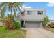 Gray two-story house with attached garage and palm trees at 1118 2Nd S Ave, Tierra Verde, FL 33715