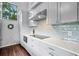 Modern kitchen with gray cabinets and white quartz countertops at 1118 2Nd S Ave, Tierra Verde, FL 33715