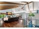 Open living room with high ceilings, exposed beams, and hardwood floors at 1118 2Nd S Ave, Tierra Verde, FL 33715