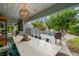 White patio table with seating near the pool at 1118 2Nd S Ave, Tierra Verde, FL 33715