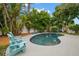 Relaxing kidney-shaped pool with blue lounge chairs at 1118 2Nd S Ave, Tierra Verde, FL 33715