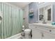 Bathroom with shower/tub, white vanity, and marble tile at 17104 Carrington Park Dr # 520, Tampa, FL 33647