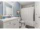Bathroom with tub, shower, white vanity, and marble tile at 17104 Carrington Park Dr # 520, Tampa, FL 33647