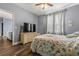 Bedroom with large TV and coastal bedding at 17104 Carrington Park Dr # 520, Tampa, FL 33647