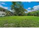 Expansive grassy lawn area with mature trees and landscaping at 4001 58Th N St # 28, St Petersburg, FL 33709