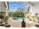 Enclosed pool and patio area with lush landscaping at 8432 Dunham Station Dr, Tampa, FL 33647