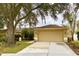Attached garage with driveway and landscaping at 2321 Rothenfeld Ct, Land O Lakes, FL 34639