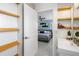 Modern bathroom with a floating vanity and bamboo shelving at 1190 Rue Des Chateaux # 2A, South Pasadena, FL 33707