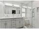 Modern bathroom with double vanity, a large mirror, and glass shower at 5853 Leeland S St, St Petersburg, FL 33715