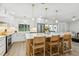 Modern kitchen with large island, white cabinets, and stainless steel appliances at 5853 Leeland S St, St Petersburg, FL 33715