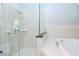 Bathroom with marble tile, glass shower door, and a soaking tub at 803 W Sligh Ave, Tampa, FL 33604