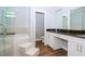 Bathroom with marble tile, glass shower door, double vanity and tile floors at 803 W Sligh Ave, Tampa, FL 33604