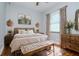 Comfortable bedroom with a rustic decor and natural light from the window at 803 W Sligh Ave, Tampa, FL 33604