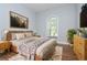 Cozy bedroom featuring a wooden headboard, soft rug, and blue painted walls at 803 W Sligh Ave, Tampa, FL 33604