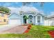 Charming blue single-story home with a well-manicured lawn and inviting curb appeal at 803 W Sligh Ave, Tampa, FL 33604