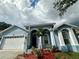 Home exterior with a two-car garage and arched entries at 803 W Sligh Ave, Tampa, FL 33604