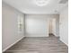 Bright bedroom with grey wood-look floors and a large closet at 1580 Bering Rd, Wesley Chapel, FL 33543