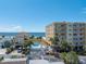 Aerial view showing beach, pool, and building at 13426 Gulf Blvd, Madeira Beach, FL 33708