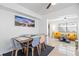 Bright dining area with table and chairs, and adjacent seating area at 13426 Gulf Blvd, Madeira Beach, FL 33708