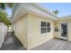 Light yellow house exterior with a grey deck at 13426 Gulf Blvd, Madeira Beach, FL 33708