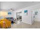 Bright living room with yellow accent chairs and gray sofa at 13426 Gulf Blvd, Madeira Beach, FL 33708