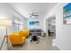 Living area featuring gray sofa and yellow armchairs at 13426 Gulf Blvd, Madeira Beach, FL 33708